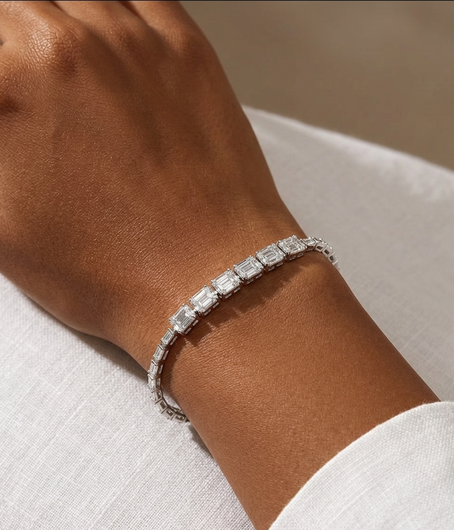 Silver bracelet on a wrist with a neutral background