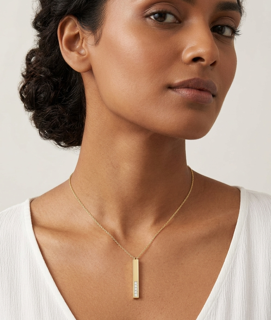 Woman wearing a gold necklace with a white background