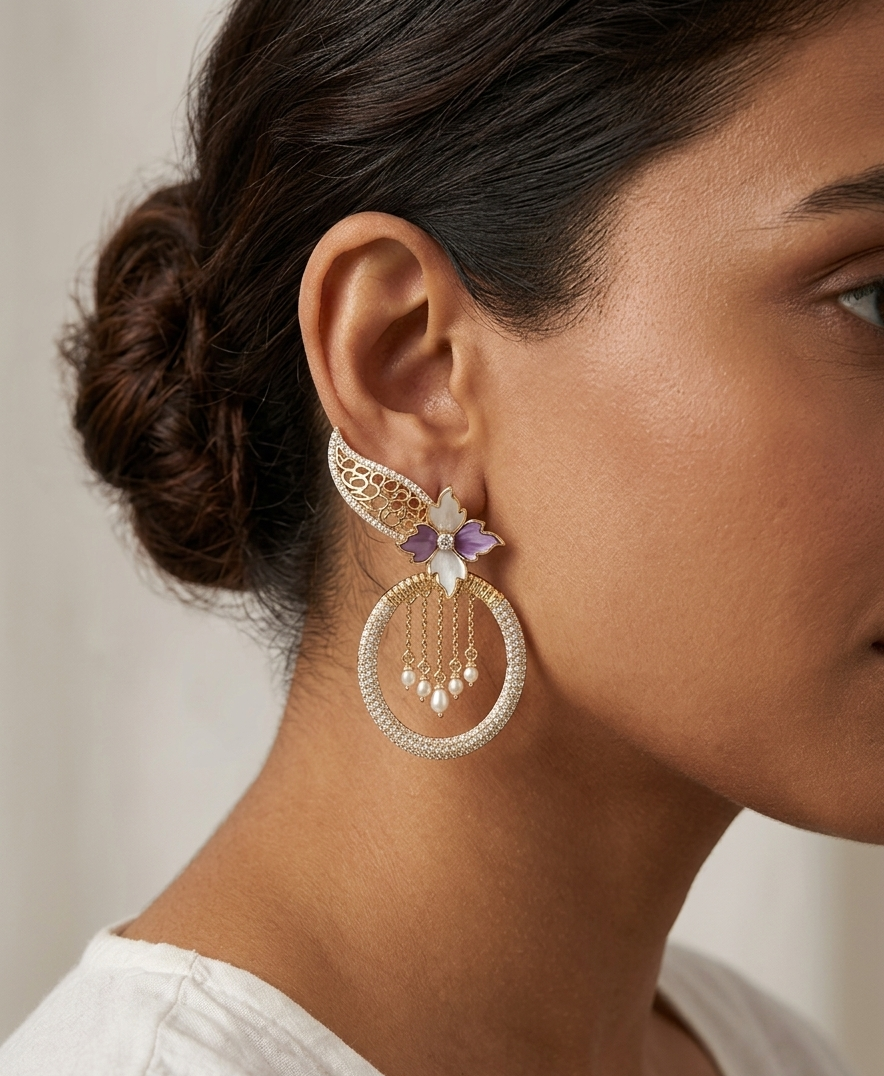 Close-up of a woman wearing gold hoop earrings with purple accents.