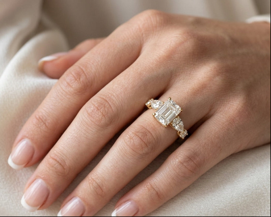 Hand wearing a diamond ring on a soft beige background