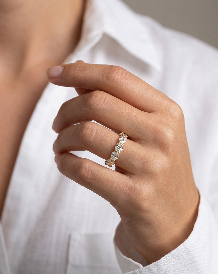 Hand wearing a diamond ring with a blurred background