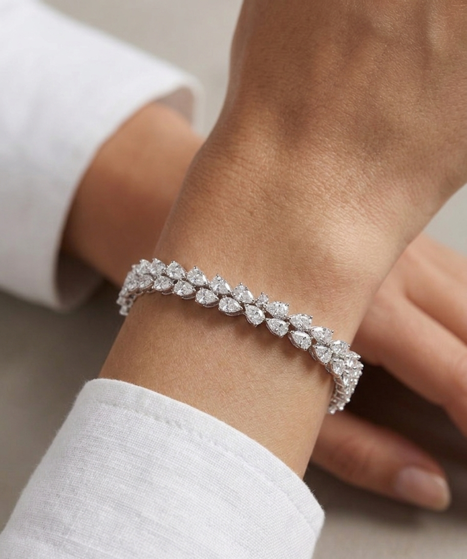 Diamond bracelet on a wrist with a neutral background