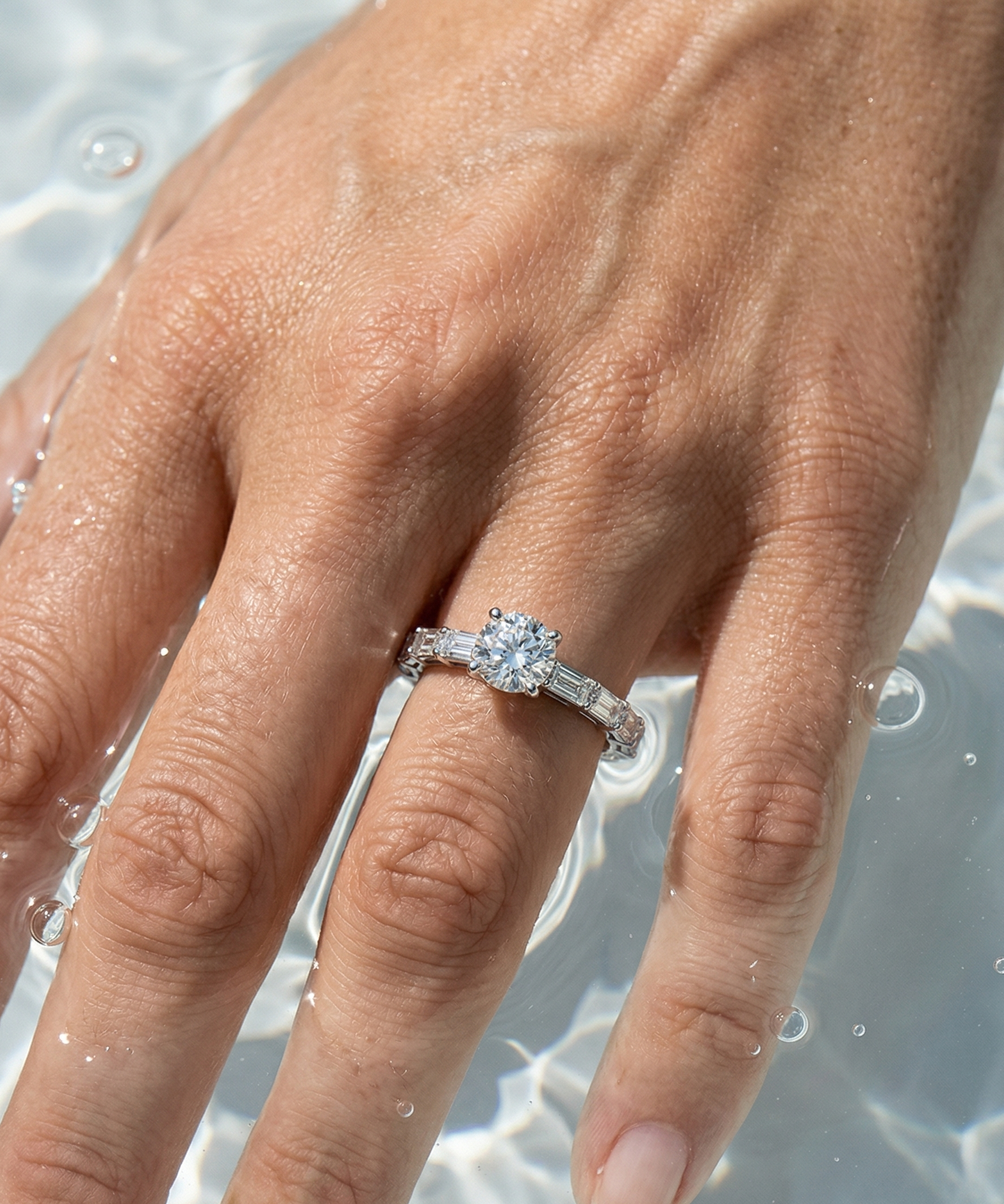Hand wearing a diamond ring with a clear background