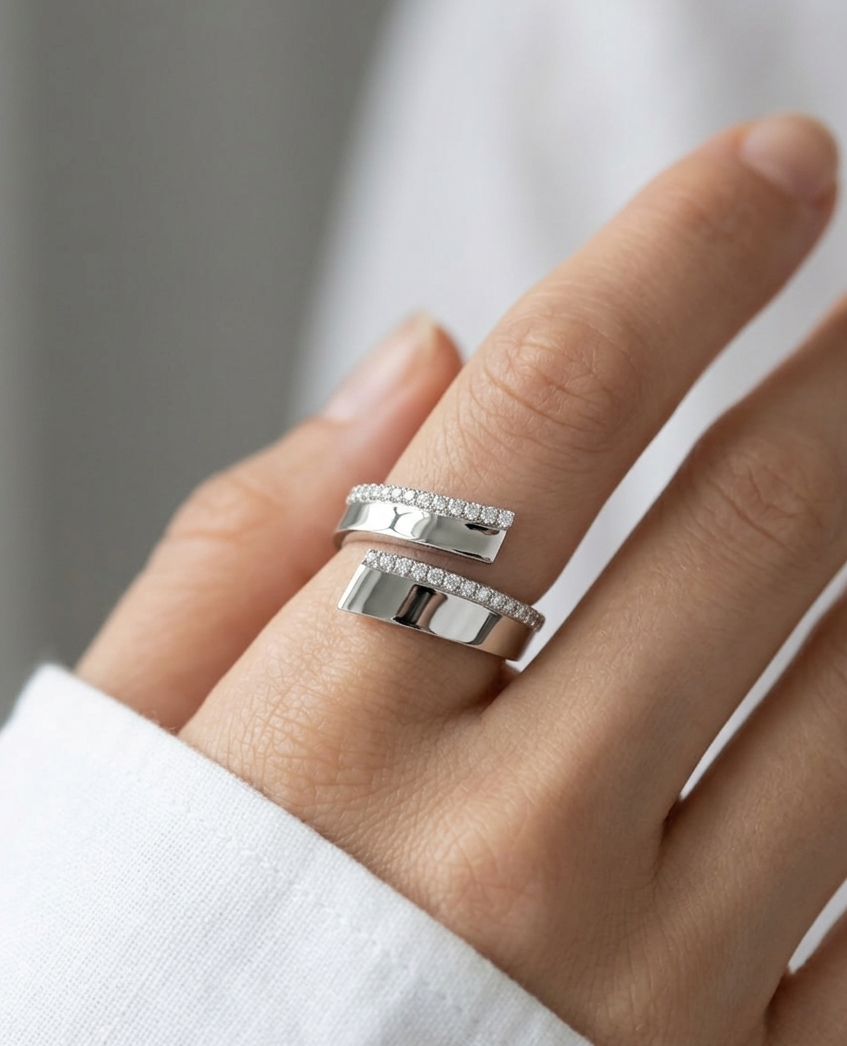 Silver ring on a finger with a neutral background