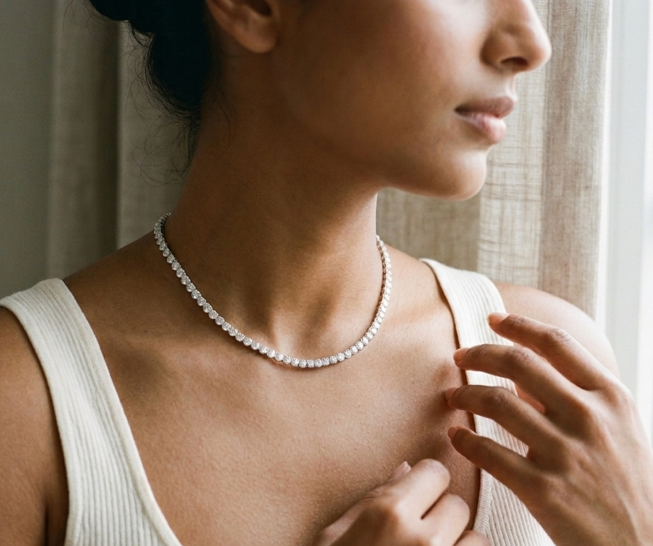 Woman wearing a pearl necklace indoors with natural light