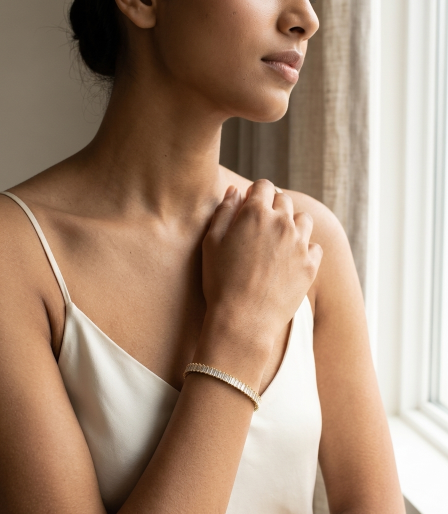 Woman wearing a white satin slip in a softly lit room.